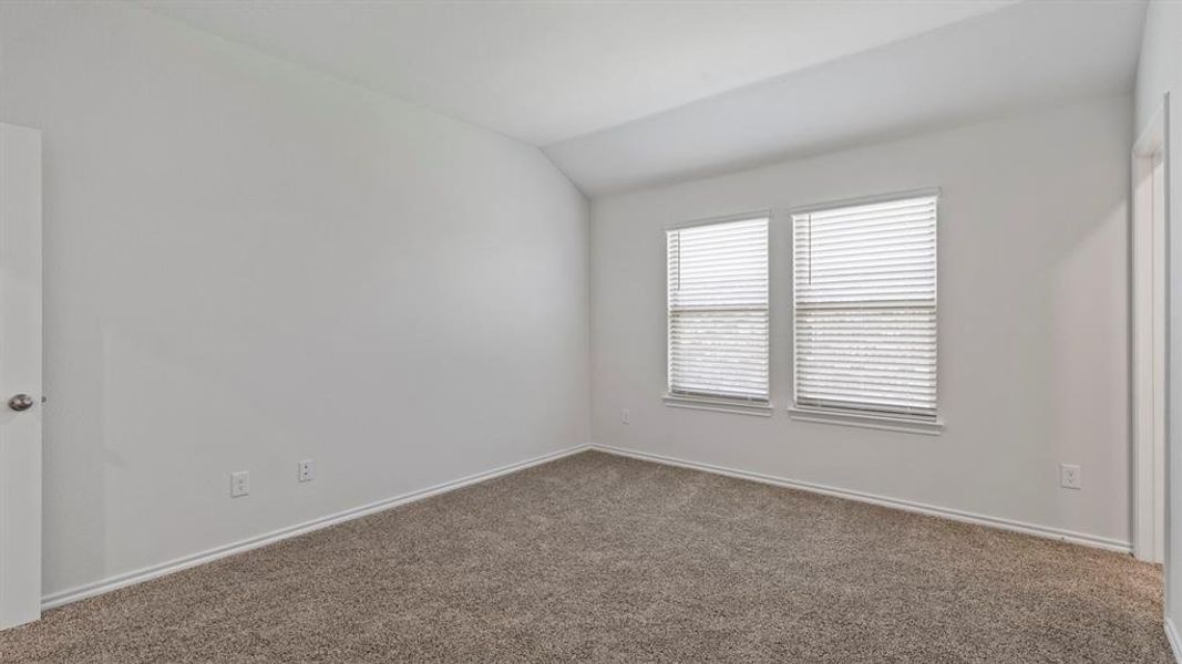 Carpeted interior room featuring two windows with horizontal blinds, white walls, and white trim