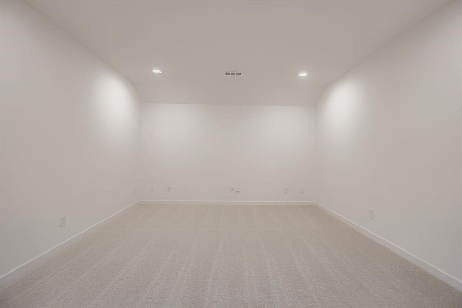 Spare room with light carpet and recessed lighting