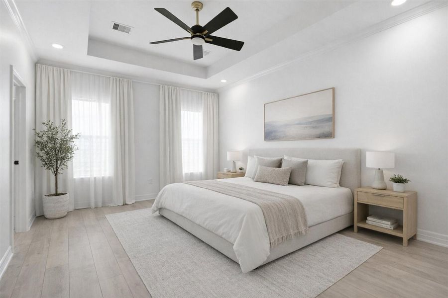 Spacious primary bedroom on the second floor featuring tray ceiling, ceiling fan, large windows, and room for a king size bed.