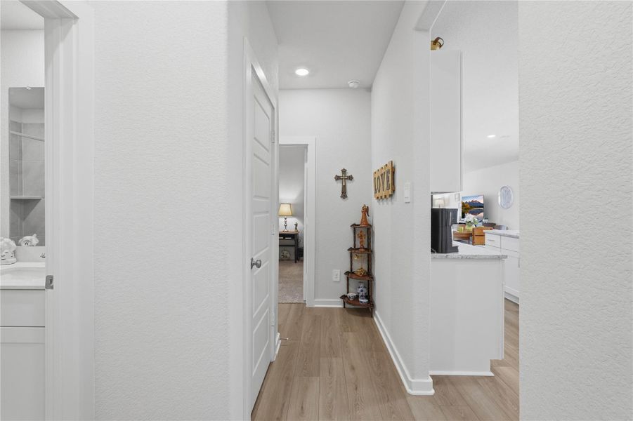 The hallway between the kitchen and spare bedrooms is a great spot to hang your favorite memories.
