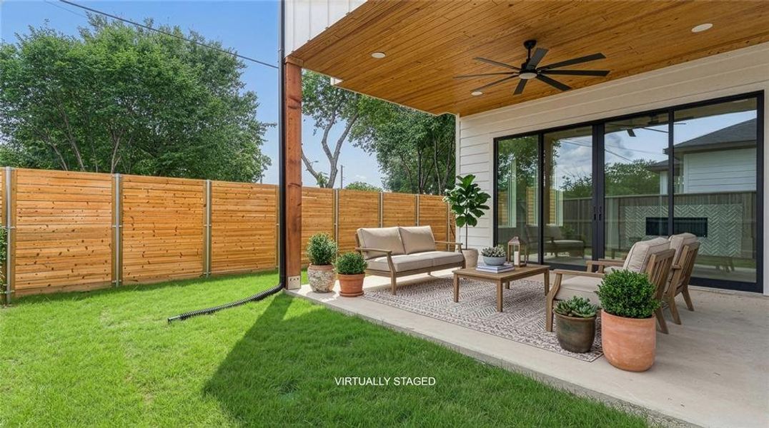 Covered patio featuring a wood-finish ceiling with a ceiling fan, concrete flooring, and multiple sliding glass doors. The patio is 13 x 17 and has a true 8 ft privacy fence around the perimeter of the backyard space. Covered patio featuring a wood-finish ceiling with a ceiling fan, concrete flooring, and multiple sliding glass doors. The patio is 13 x 17 and has a true 8 ft privacy fence around the perimeter of the backyard space.