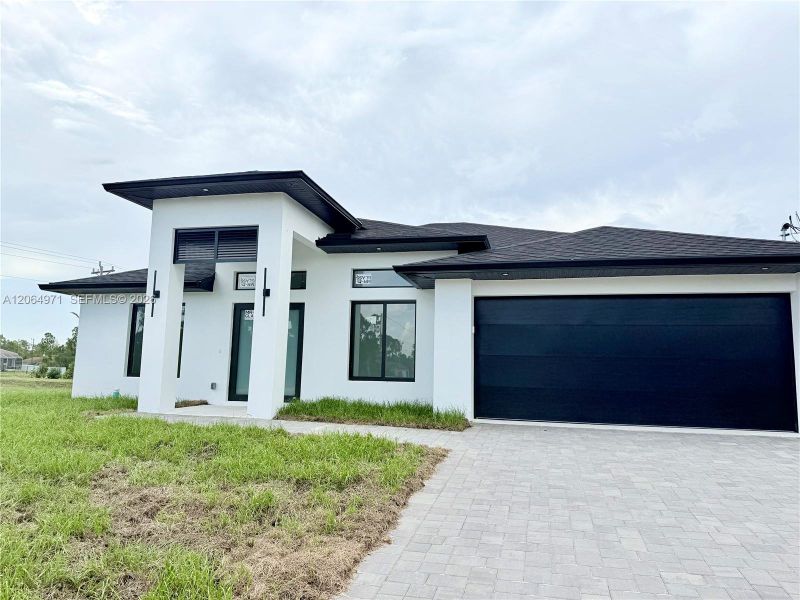 Front exterior of a new home in , Lehigh Acres, FL, highlighting curb appeal (Image 23).