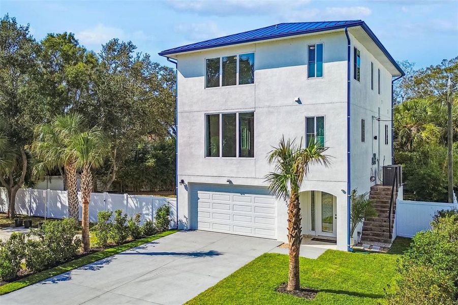 Front exterior of a new home in , Dunedin, FL, highlighting curb appeal (Image 1).