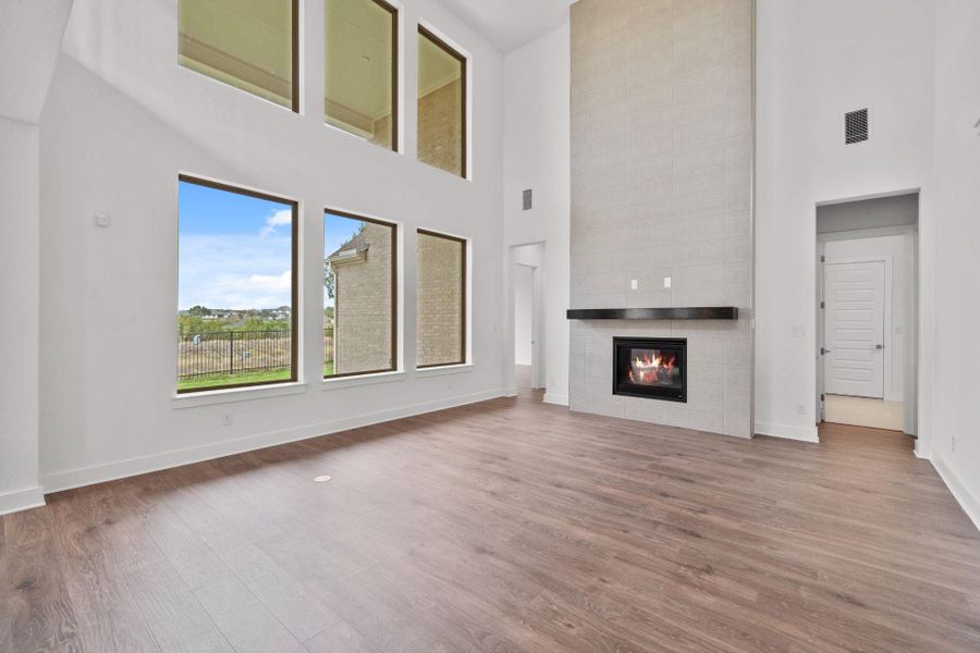 Family Room with soaring ceiling & fireplace