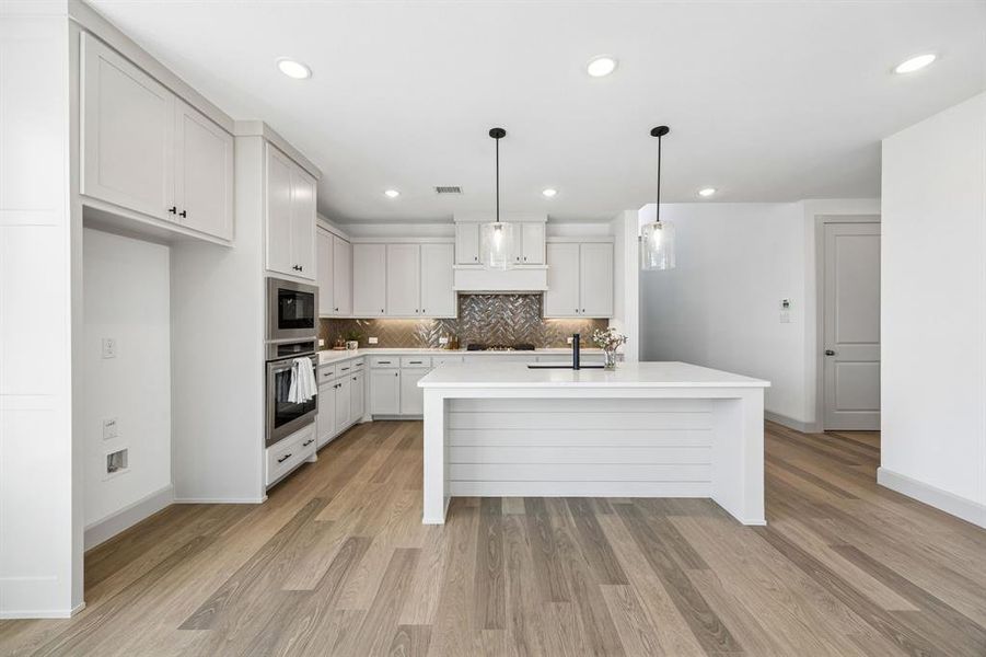 The spacious kitchen island is the perfect place for friends and family to gather round. The spacious kitchen island is the perfect place for friends and family to gather round.