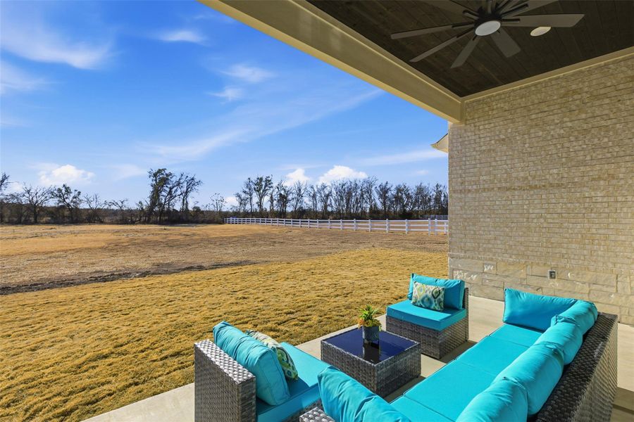 View of patio with ceiling fan and an outdoor hangout area