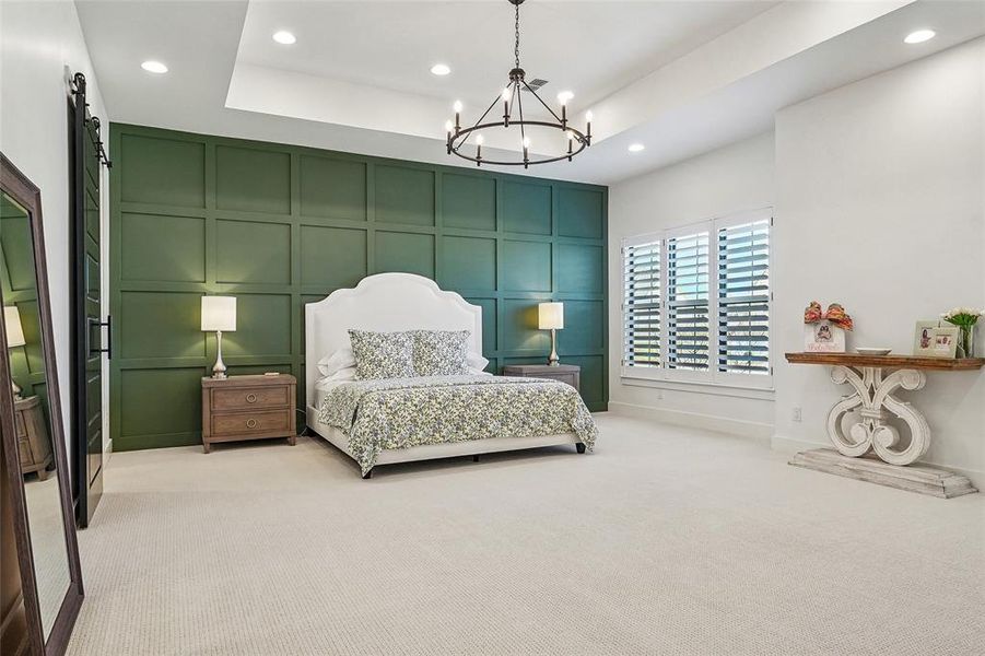 Oversized primary bedroom with custom wall paneling