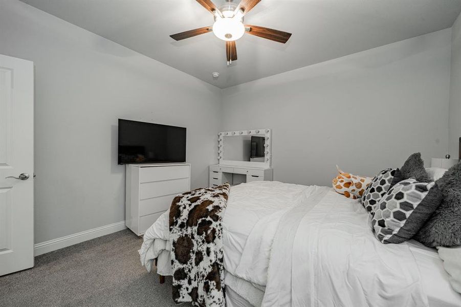 Bedroom featuring carpet flooring and a ceiling fan Bedroom featuring carpet flooring and a ceiling fan