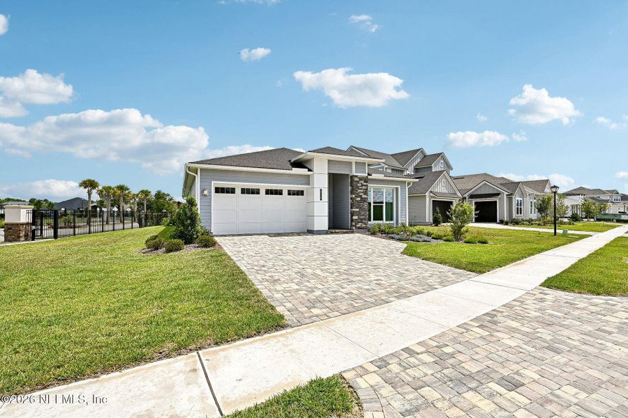 Front exterior of a new home in SilverLeaf, St. Augustine, FL, highlighting curb appeal (Image 2). Front exterior of a new home in SilverLeaf, St. Augustine, FL, highlighting curb appeal (Image 2).