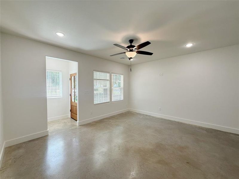 Unfurnished room featuring finished concrete flooring, recessed lighting, and a ceiling fan