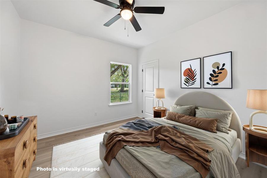 Bedroom featuring wood finished floors and ceiling fan