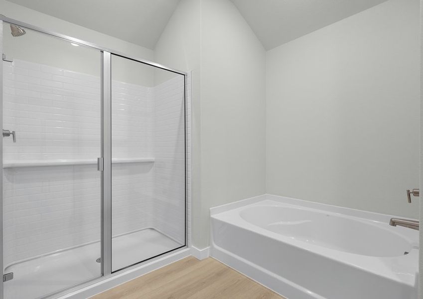 Master bath has a separate tub and walk-in shower.