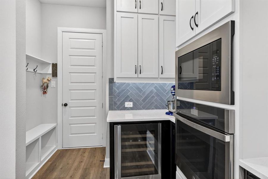 Wine refrigerator & mud area off garage