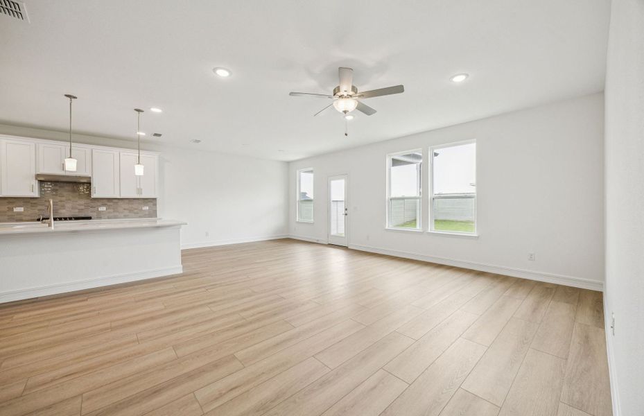 Open concept gathering room creating a spacious and inviting atmosphere  *Real home pictured