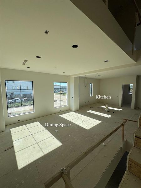 Open-concept design with seamless sightlines from the Staircase into the Dining area, Kitchen, and Living Room.