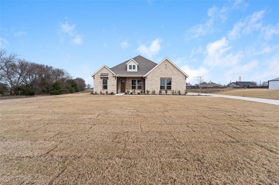 Front exterior of a new home in Nash Estates, Tom Bean, TX, highlighting curb appeal (Image 22). Front exterior of a new home in Nash Estates, Tom Bean, TX, highlighting curb appeal (Image 22).