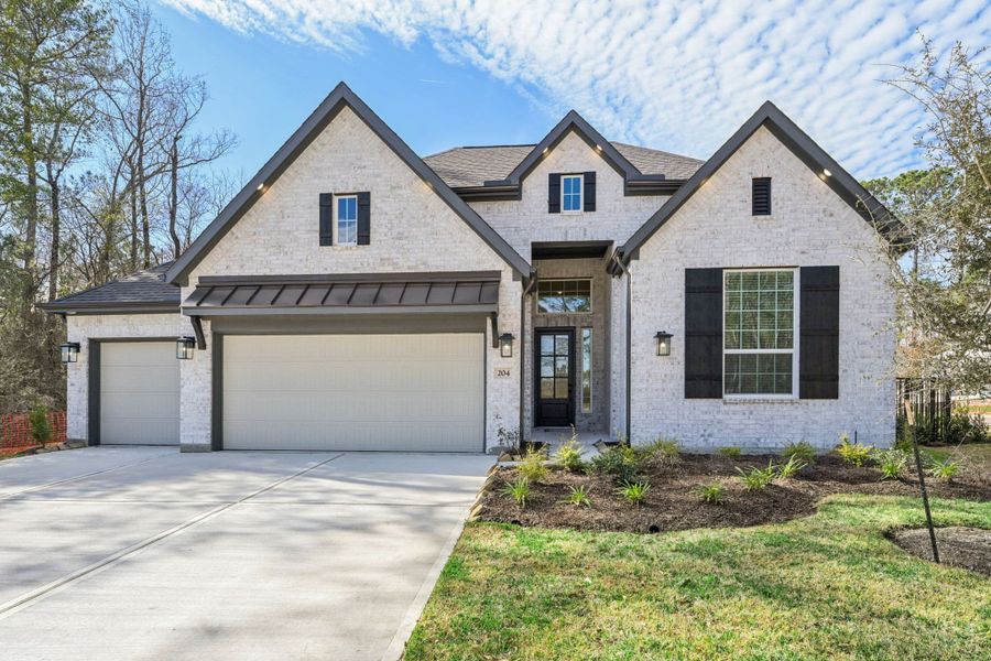 Front exterior of a new home in The Woodlands Hills, Willis, TX, highlighting curb appeal (Image 21).