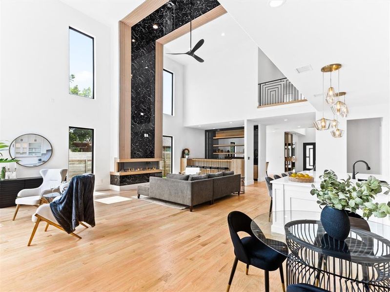 Dining room with a towering ceiling and light wood-type flooring