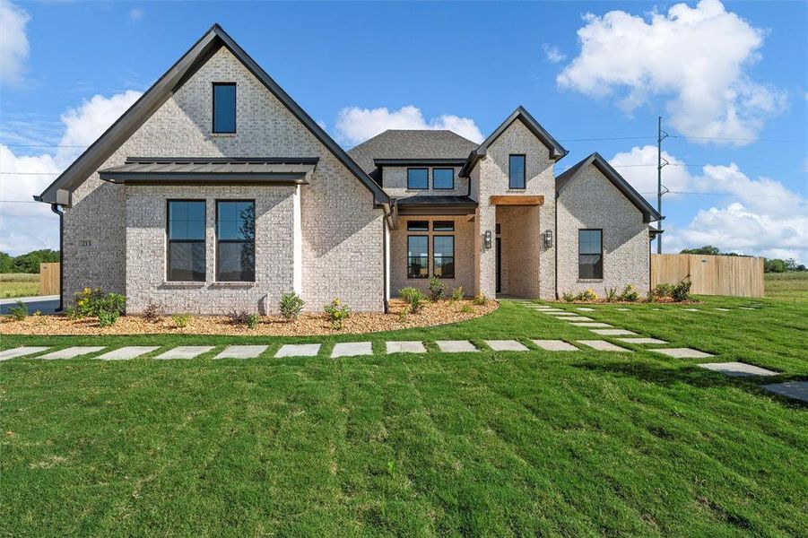 View of front facade featuring brick siding