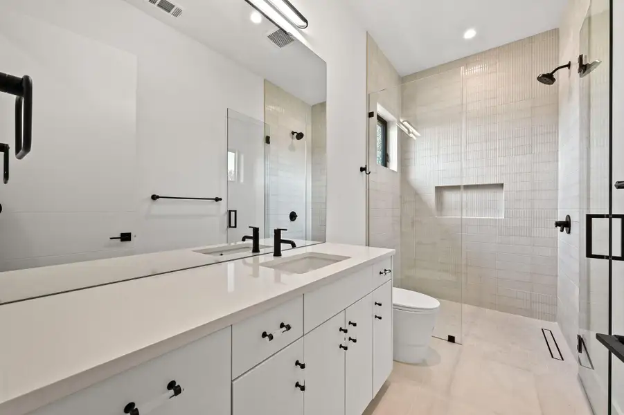 Full bathroom with vanity, a shower stall, recessed lighting, and light tile patterned flooring