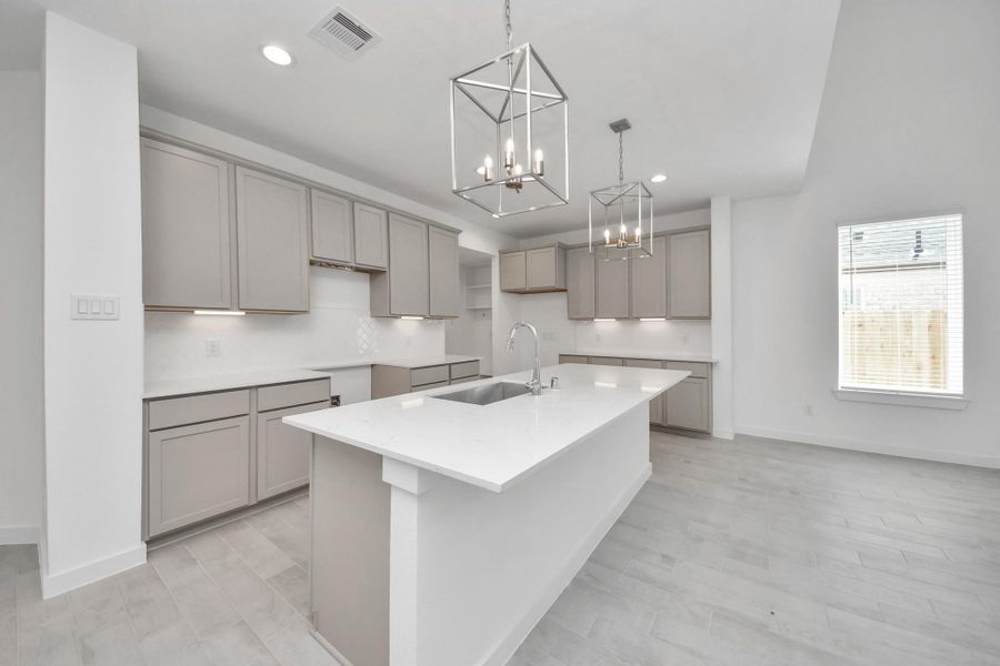 This kitchen is by far any chef’s dream! This spacious kitchen features high ceilings, light stained wood cabinets, granite countertop, SS appliances, modern tile backsplash, recessed lighting, extended counter space, granite kitchen island with double sink, and space for breakfast bar, and a walk-in pantry all overlooking your huge family room. Sample photo of completed home with similar floor plan. Actual colors and selections may vary.