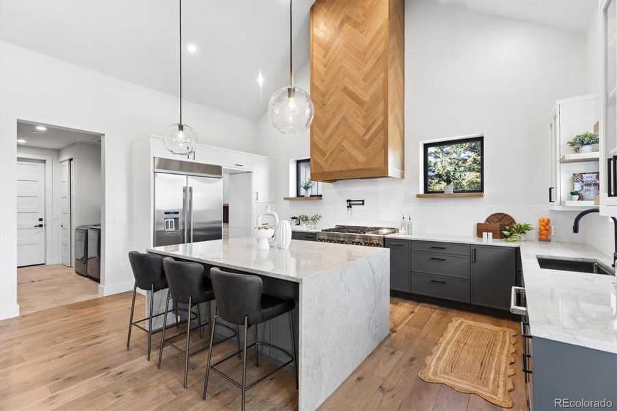 Thoughtful main floor design - space flows effortlessly from the kitchen into a massive hidden pantry and adjacent laundry room Thoughtful main floor design - space flows effortlessly from the kitchen into a massive hidden pantry and adjacent laundry room