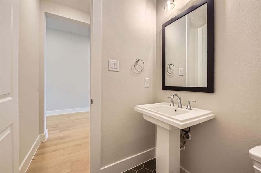 Bathroom featuring toilet and wood finished floors Bathroom featuring toilet and wood finished floors