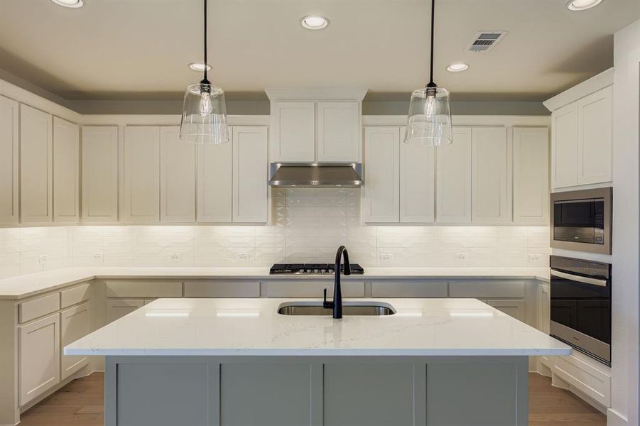 Kitchen with pendant lighting, dark wood-style floors, a center island with sink, backsplash, and recessed lighting Kitchen with pendant lighting, dark wood-style floors, a center island with sink, backsplash, and recessed lighting