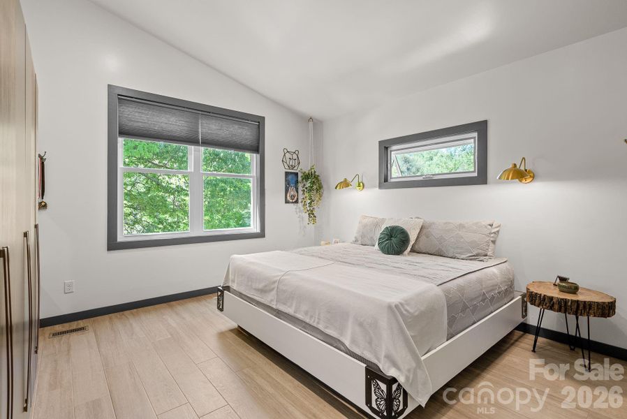 The owner's suite offers vaulted ceiling, natural light & strategically placed transom window for bed placement.