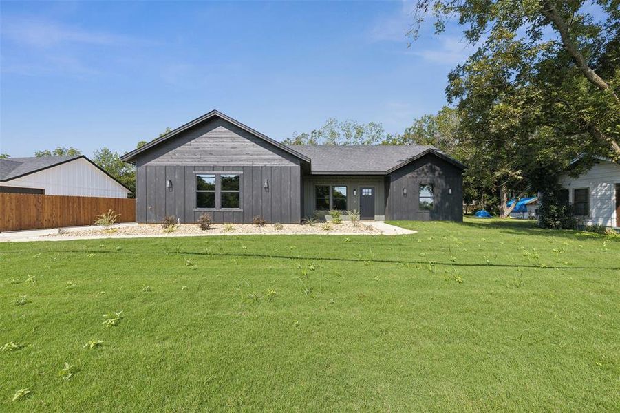 Rear view of house with a yard