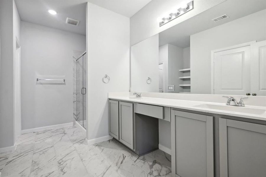 Bathroom with a shower with door and vanity