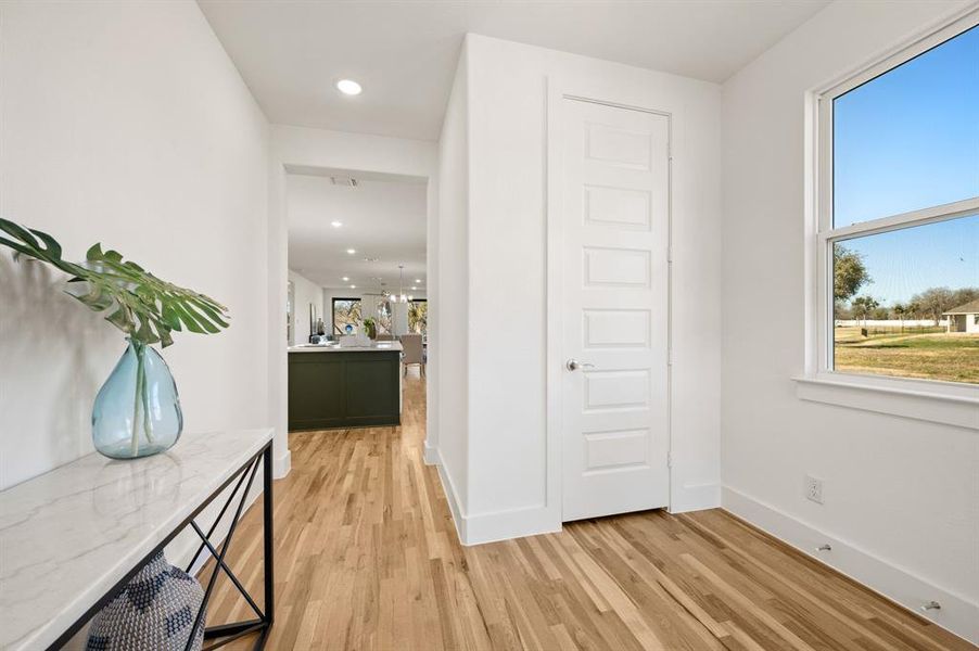 Hall featuring light wood-style floors and recessed lighting