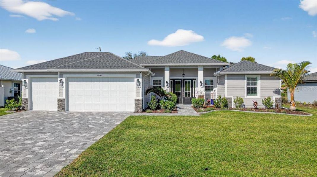 Front exterior of a new home in , Punta Gorda, FL, highlighting curb appeal (Image 1).