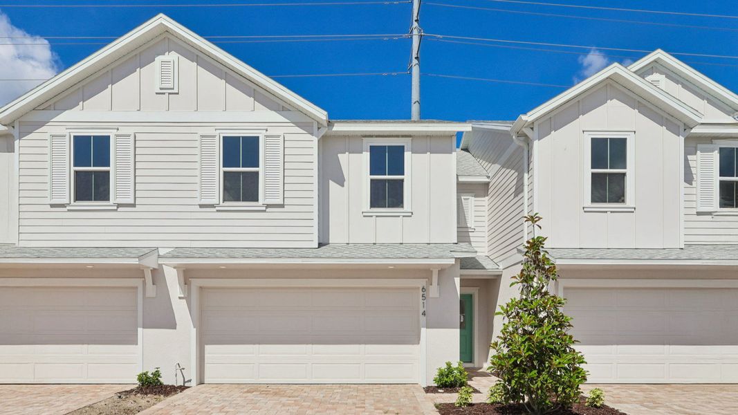 Front exterior of a new home in Cyrene at Harmony, St. Cloud, FL, highlighting curb appeal (Image 2). Front exterior of a new home in Cyrene at Harmony, St. Cloud, FL, highlighting curb appeal (Image 2).