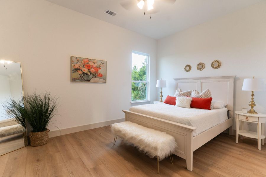 Bedroom featuring light wood finished floors and ceiling fan Bedroom featuring light wood finished floors and ceiling fan