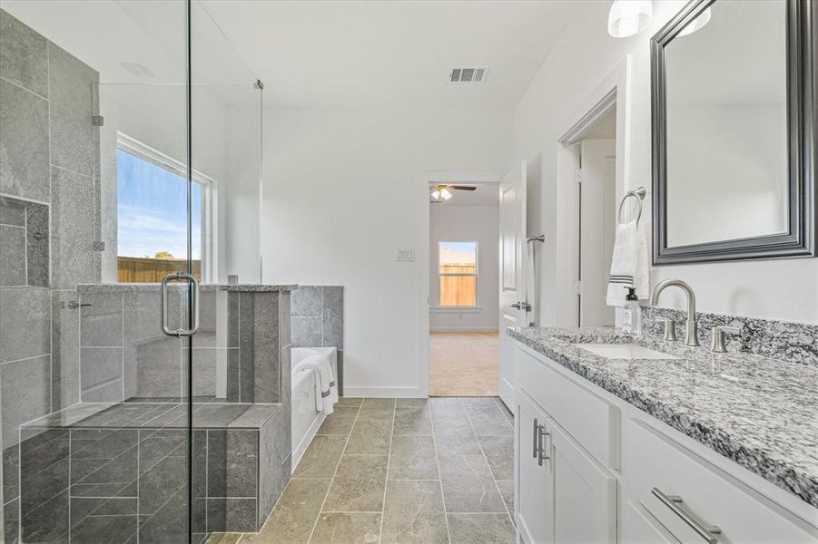 Bathroom featuring separate shower and tub and vanity Bathroom featuring separate shower and tub and vanity