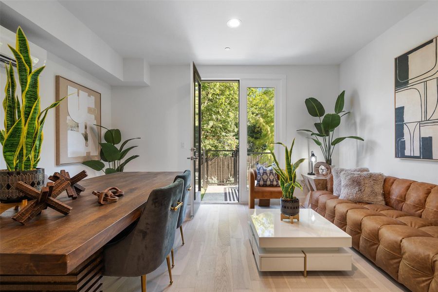 Living area featuring light wood finished floors and recessed lighting