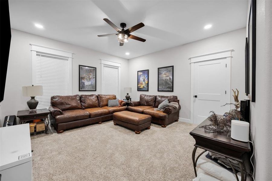 Living room featuring ceiling fan and carpet floors