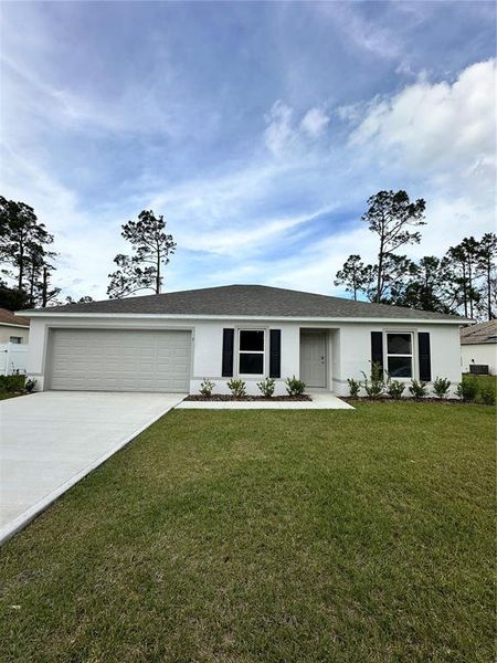 Front exterior of a new home in Palm Coast: Value Collection, Palm Coast, FL, highlighting curb appeal (Image 1).