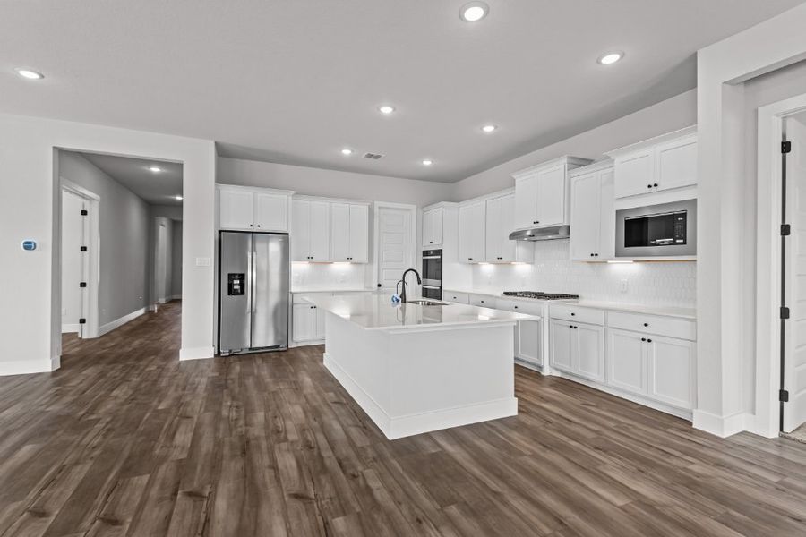 A kitchen with white cabinets.