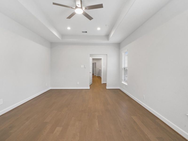 Your primary bedroom provides a serene retreat with generous space, natural light, and the perfect setting to unwind. Image depicts home as-is.