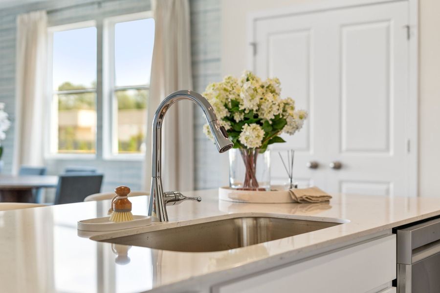 A sink with flowers in it. A sink with flowers in it.