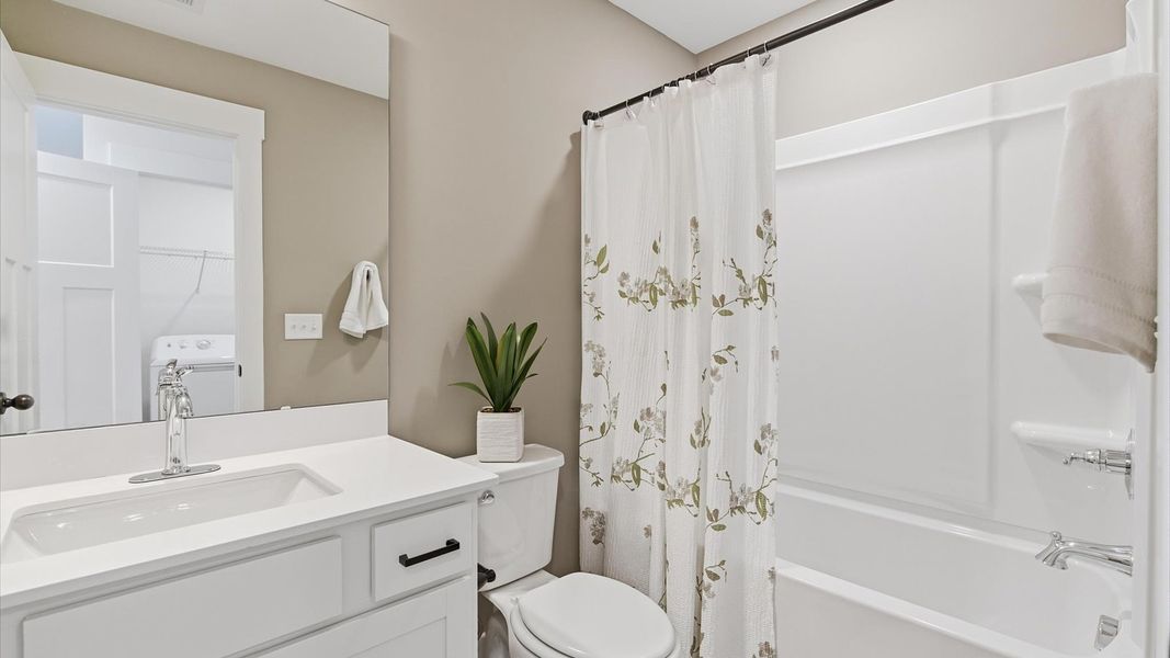Elegant bath retreat of The Churchill Design with designer finishes and a clean, timeless aesthetic