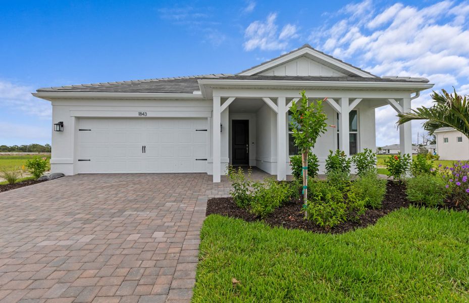 Front exterior of a new home in Shores at Stillwater, Englewood, FL, highlighting curb appeal (Image 2). Front exterior of a new home in Shores at Stillwater, Englewood, FL, highlighting curb appeal (Image 2).