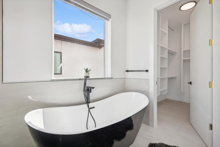 Bathroom featuring tile patterned flooring and a bathing tub