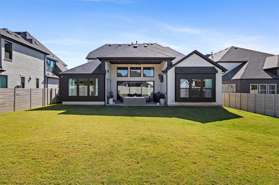 Back of property featuring a fenced backyard, a ceiling fan, a patio area, and outdoor lounge area Back of property featuring a fenced backyard, a ceiling fan, a patio area, and outdoor lounge area