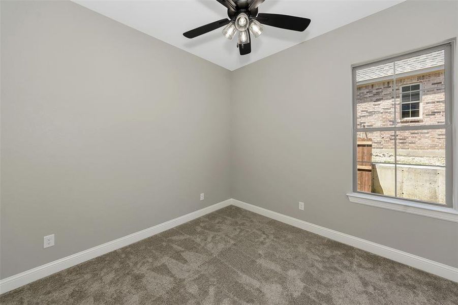Unfurnished room featuring carpet floors and ceiling fan