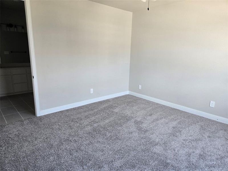 Unfurnished bedroom featuring carpet flooring and connected bathroom