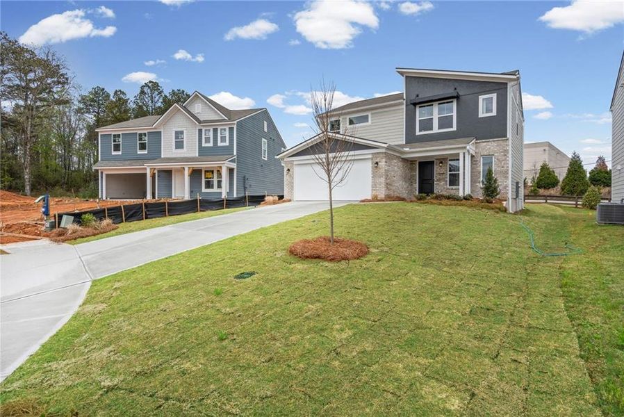 Front exterior of a new home in Crossvine Estates, Braselton, GA, highlighting curb appeal (Image 23).