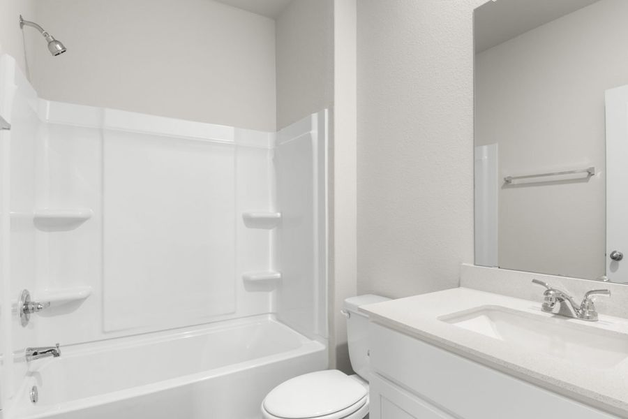 Image of second bathroom with white cabinets and mirror with a vanity with a tub and shower